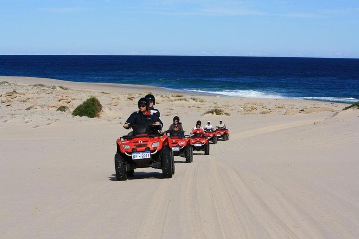 a group of people riding on atvs on the beach