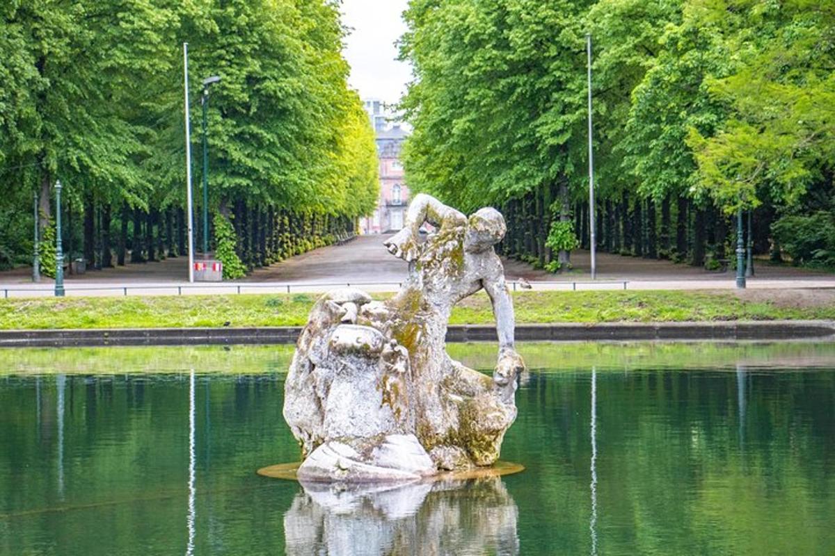 a statue in the water in a park