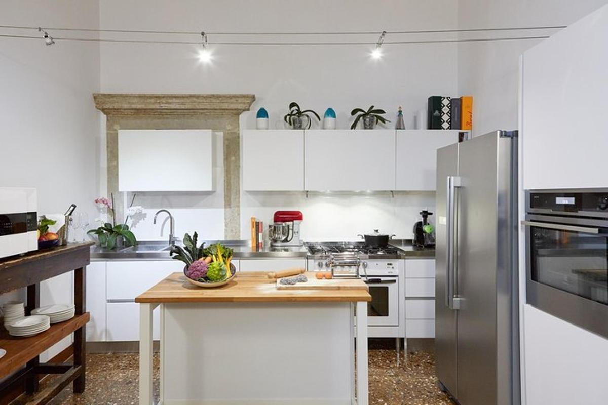 a kitchen with white cabinets and a wooden counter top
