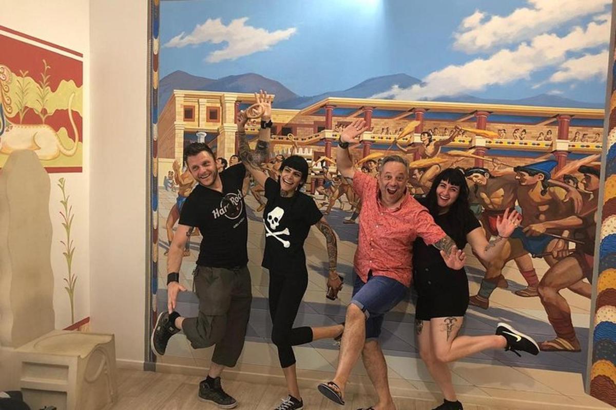 a group of people posing in front of a mural