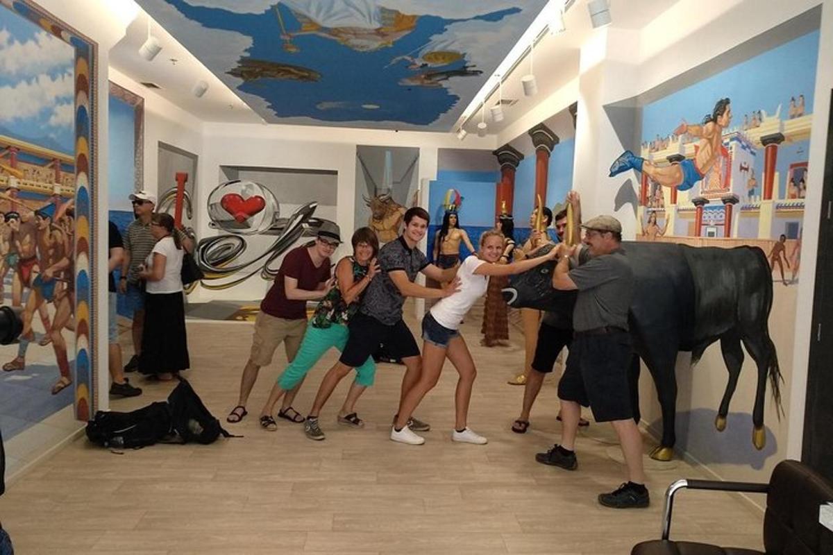 a group of people posing in front of a statue of a cow