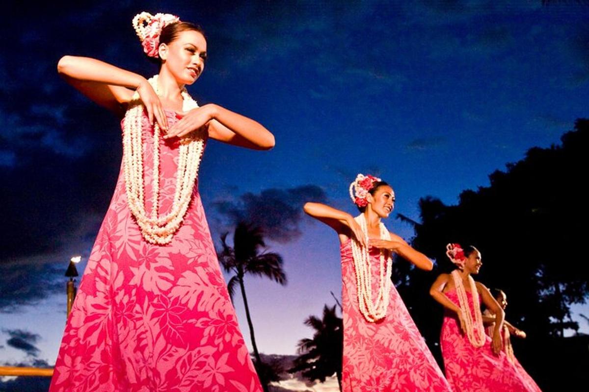 three women in pink dresses are standing together