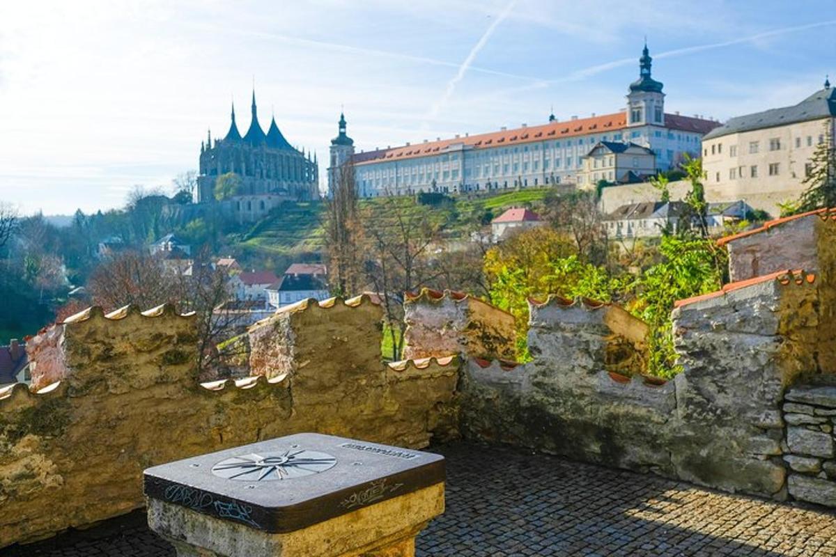 a stone bench sitting on the side of a wall with buildings