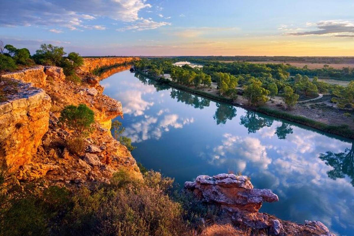 a view of a river with clouds in the water