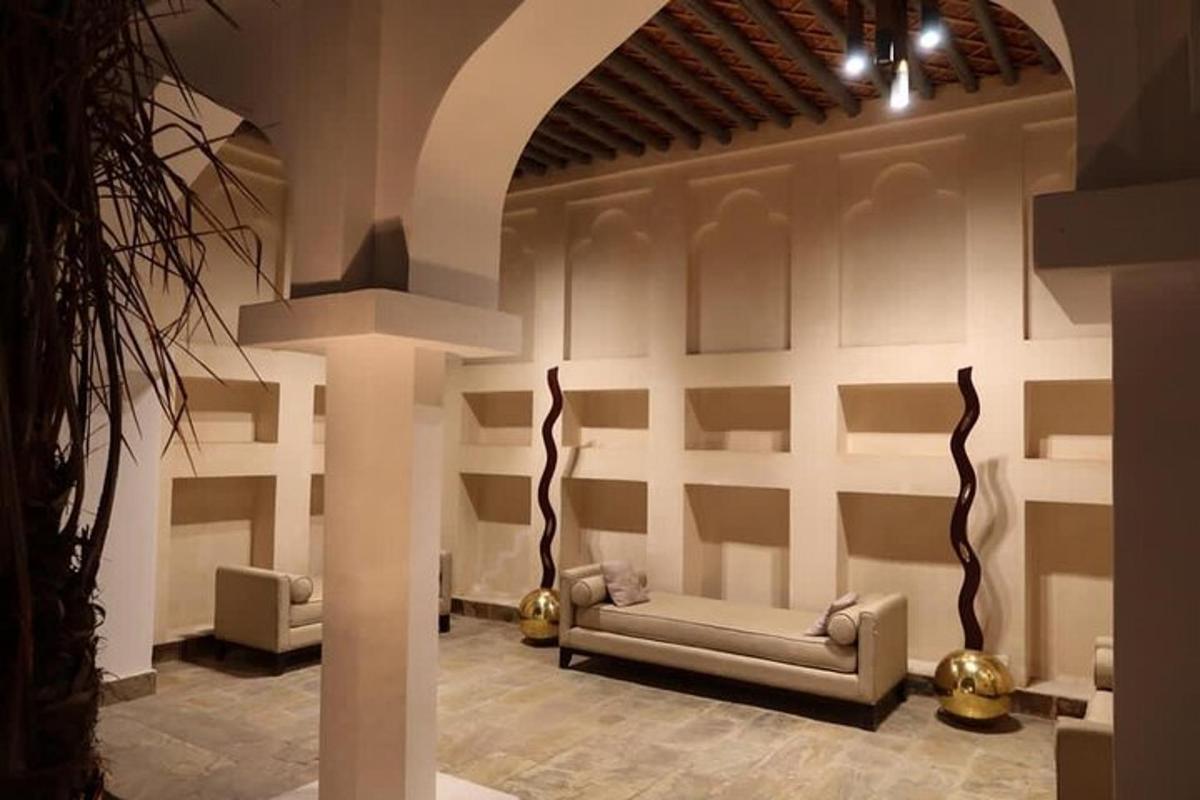a living room with a couch and a wall with shelves