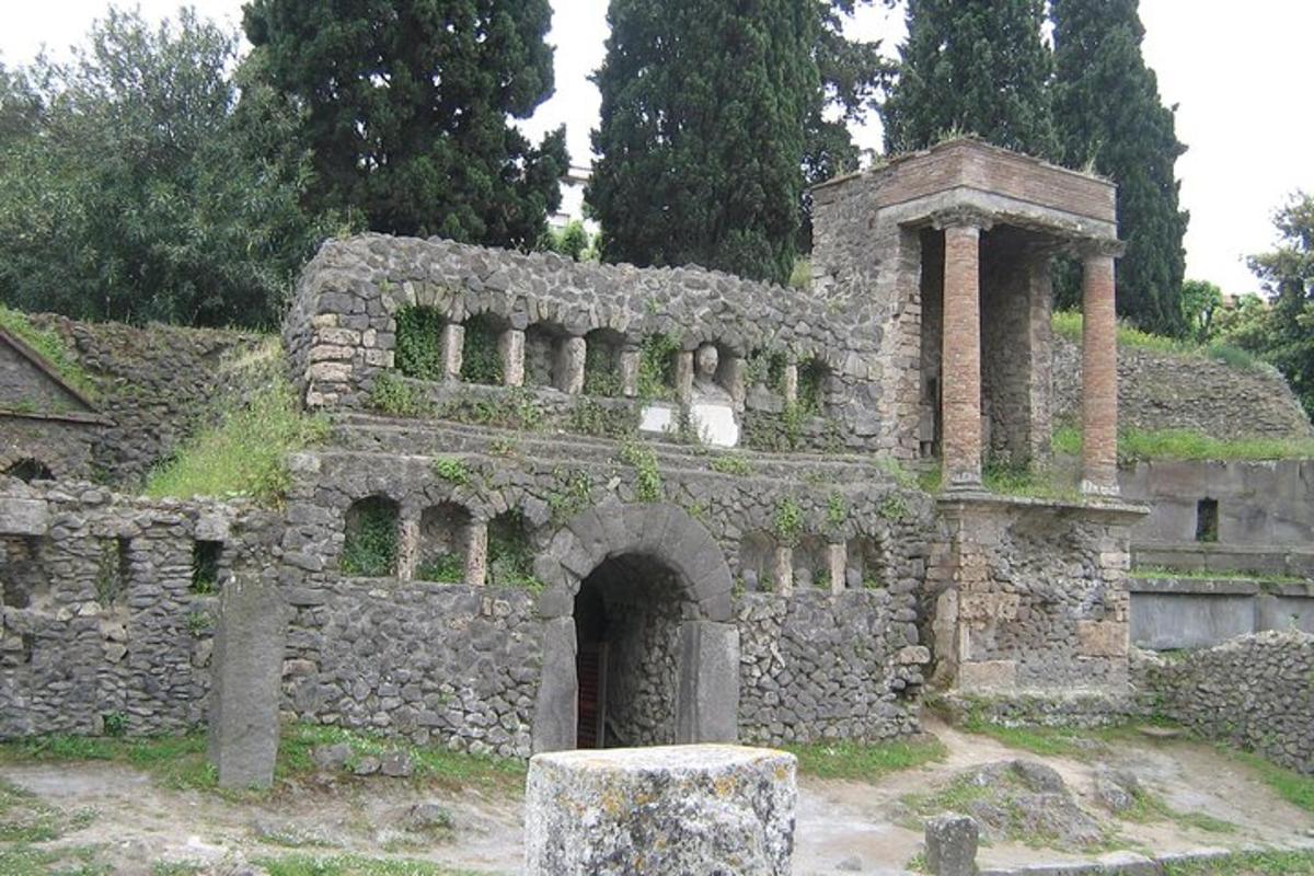 a stone building with a dog sitting on top of it