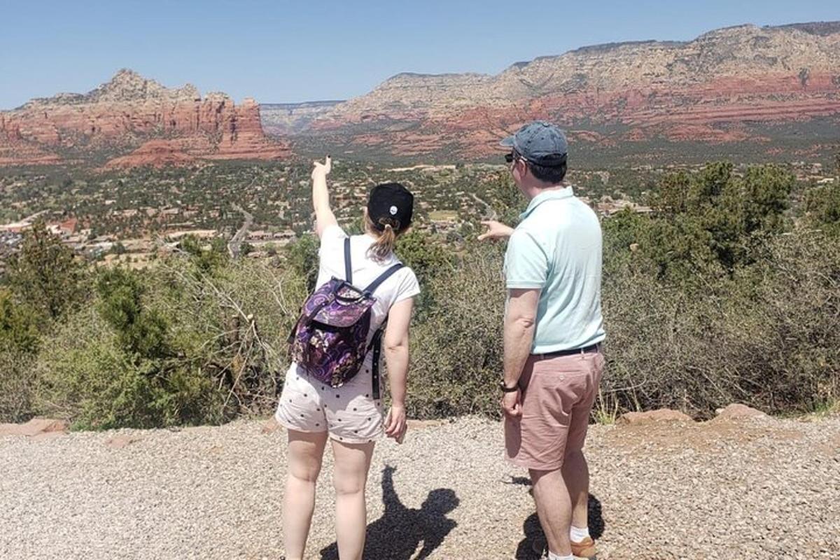 a man and a woman standing on top of a mountain