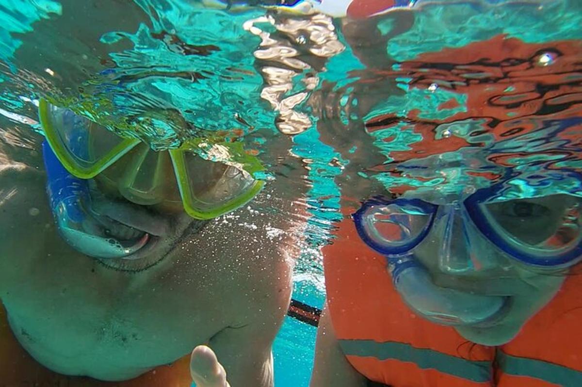 two people in a swimming pool wearing goggles