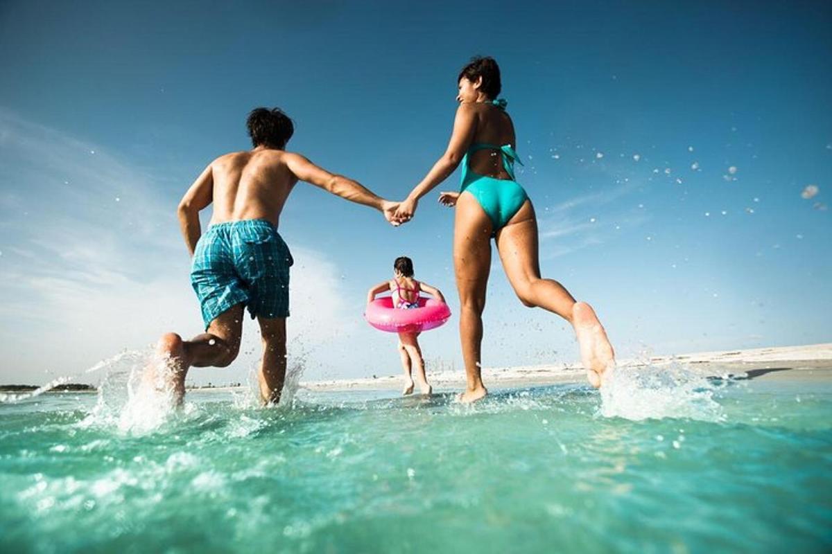 a man and woman playing in the water at the beach
