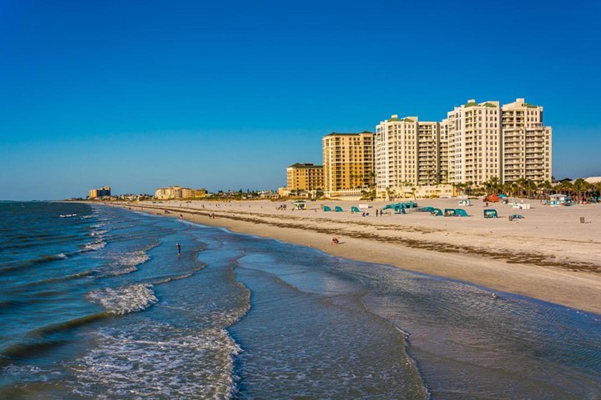 a beach with tall buildings and the ocean