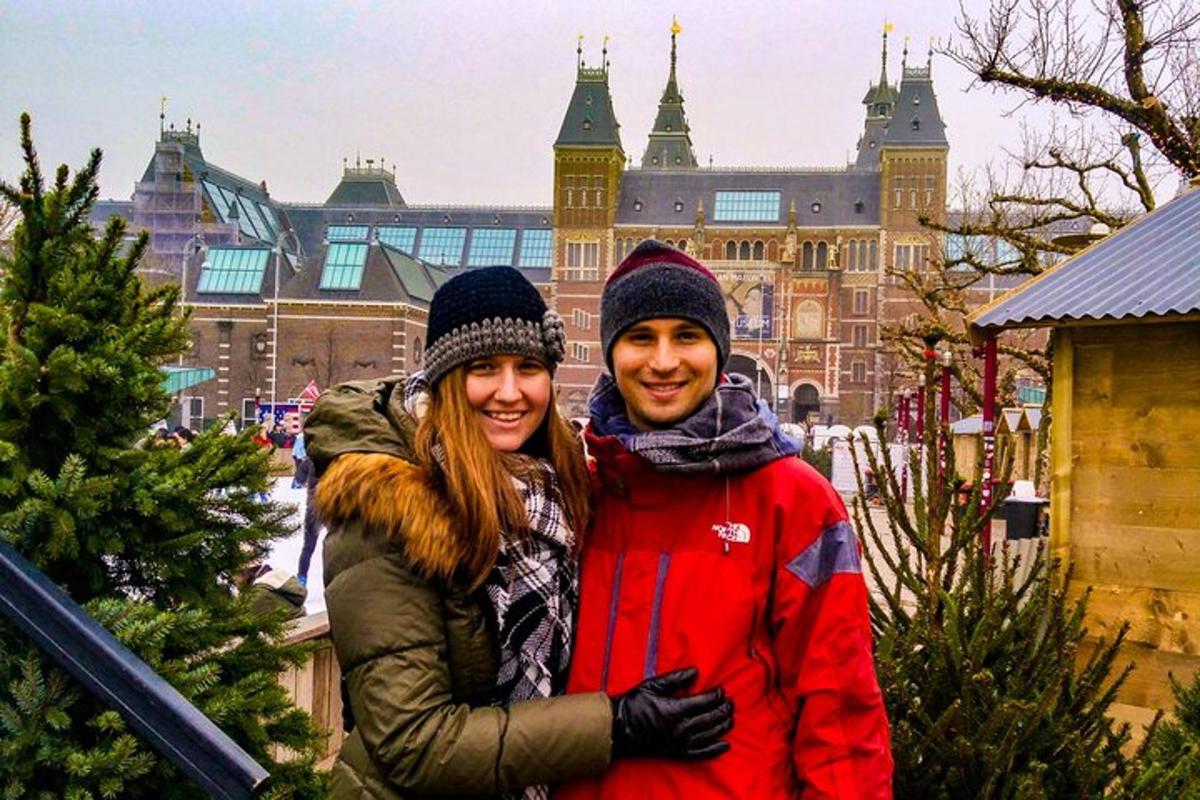 un uomo e una donna in piedi davanti a un albero di Natale