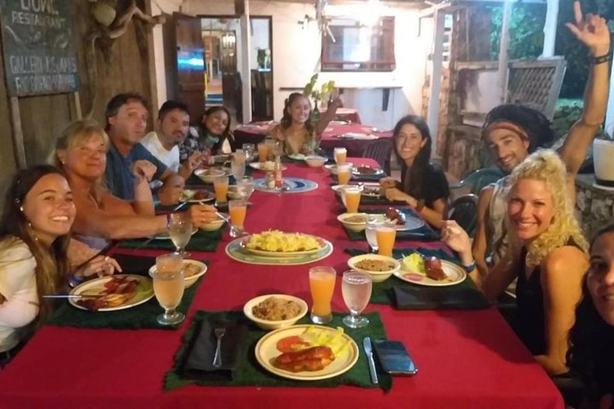 a group of people sitting around a table eating food