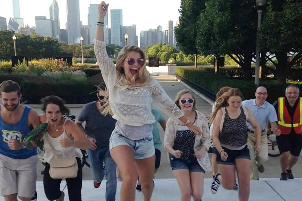 a group of people walking down a sidewalk