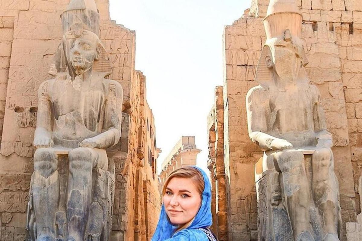 a woman standing in front of a statue