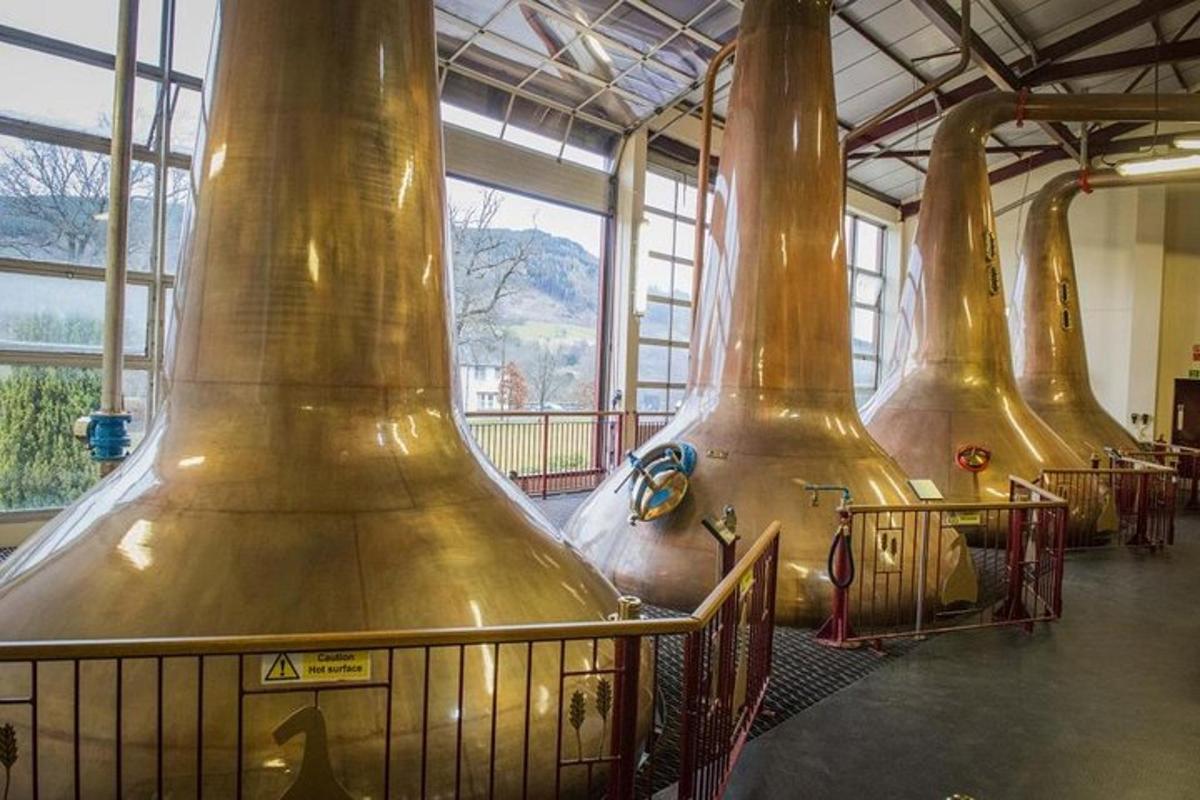 a row of large metal vases in a building