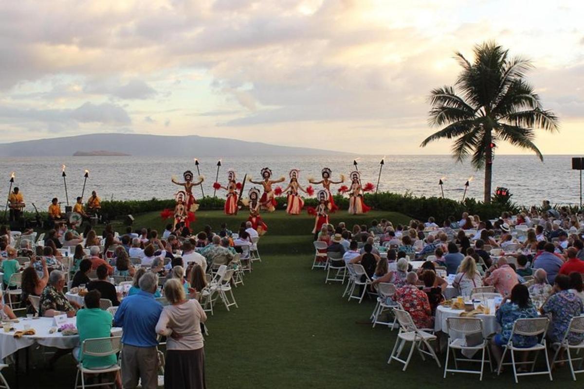 a crowd of people watching a band performing on the beach