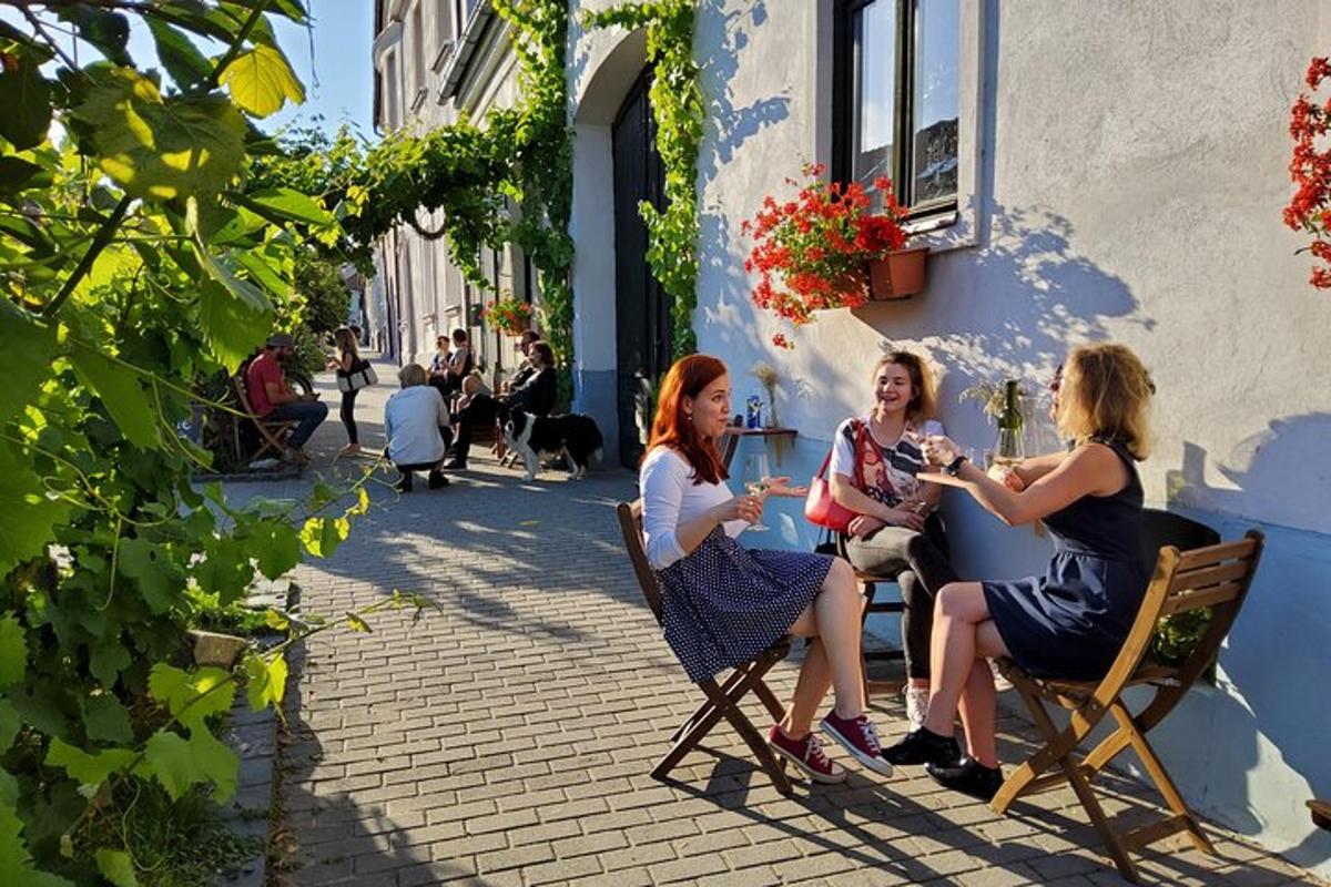 three women sitting at a table outside a building