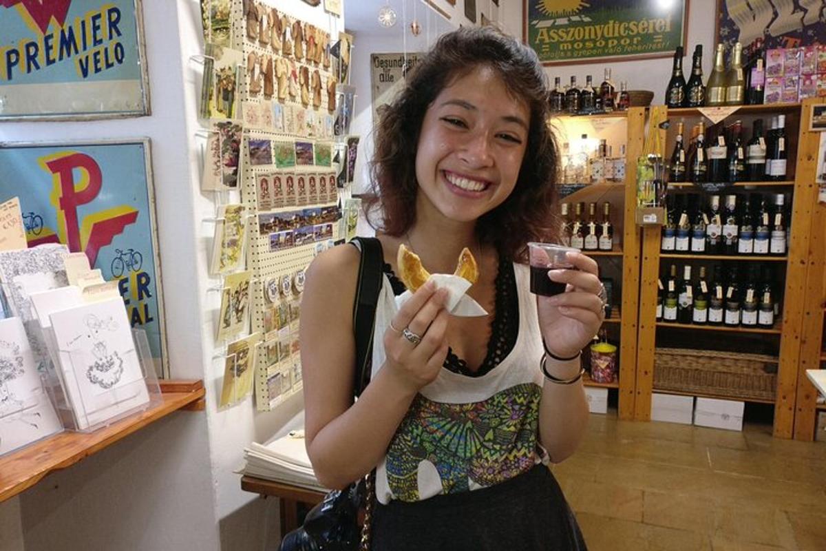 a woman is smiling while holding a glass of wine