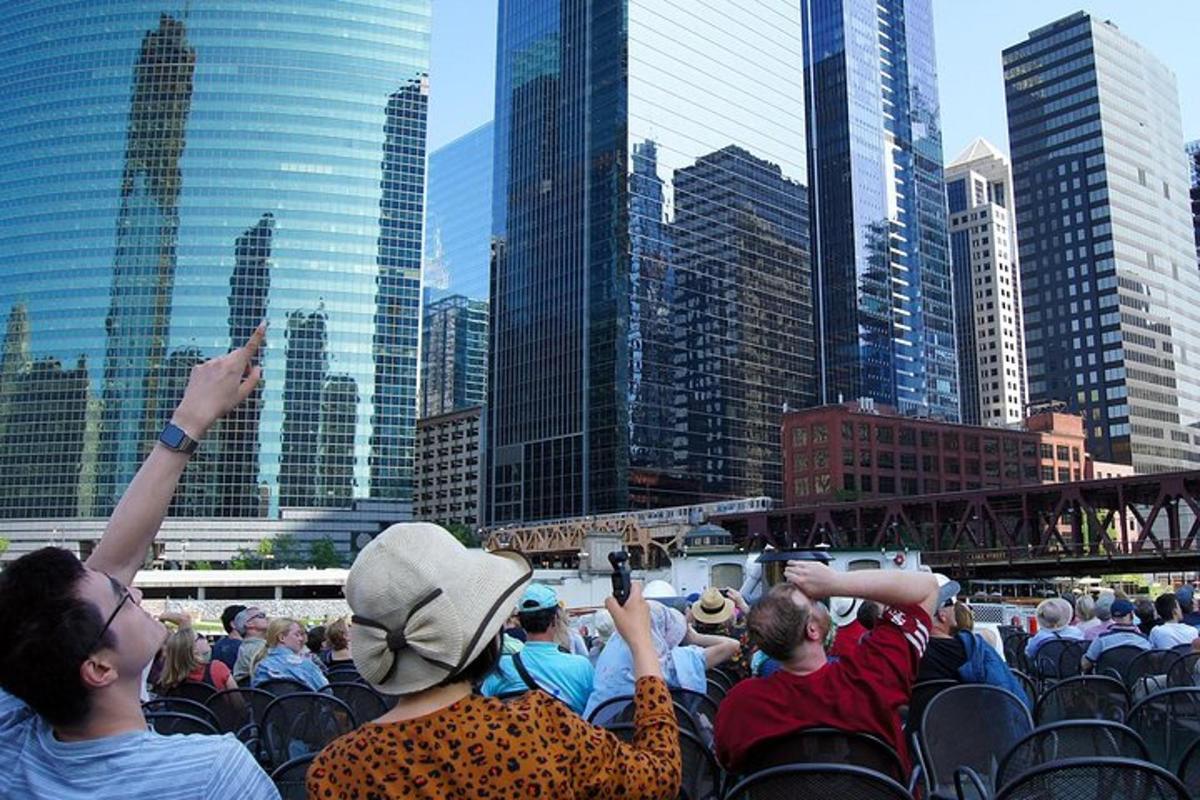 a crowd of people sitting in chairs in front of a city