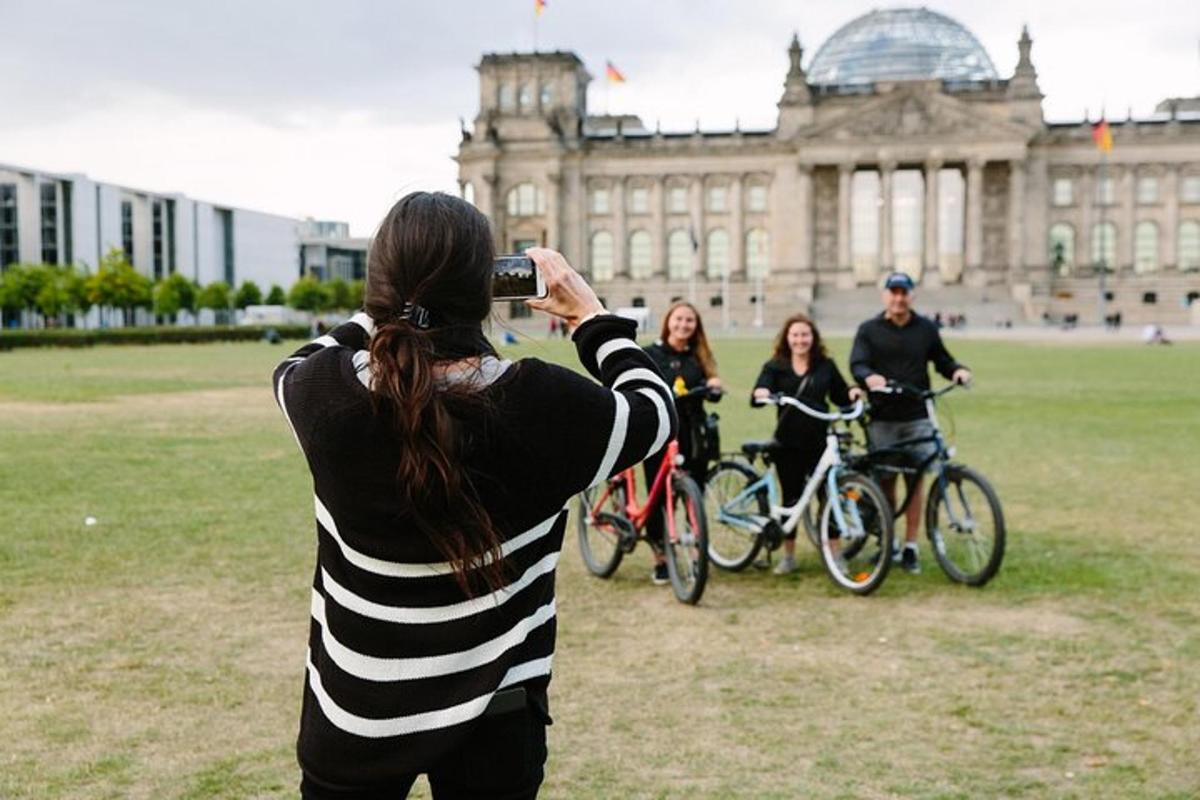 a woman taking a picture of a group of people on bikes