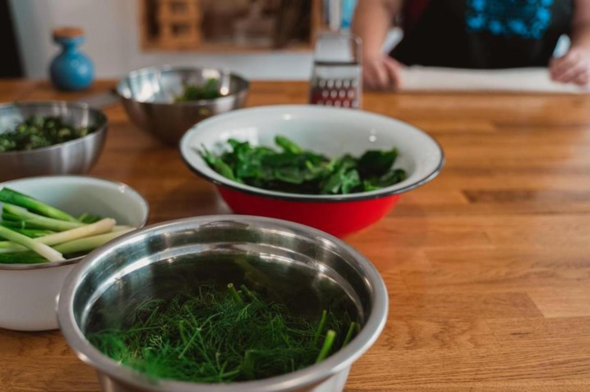 a table with bowls of vegetables on a counter
