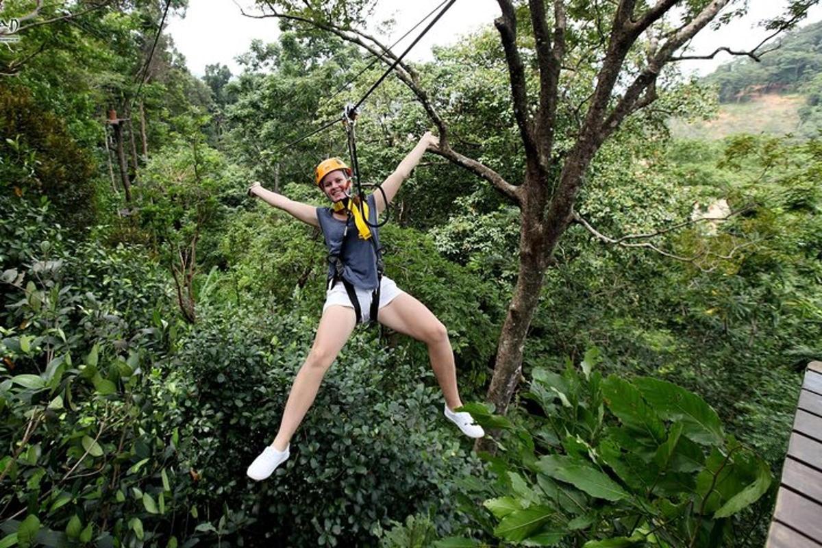 Una mujer colgada de una tirolina en los árboles.