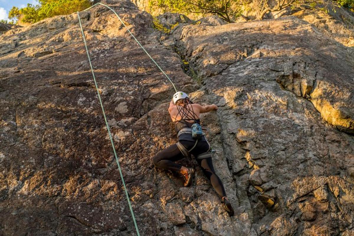 a man is on a rock climbing rope