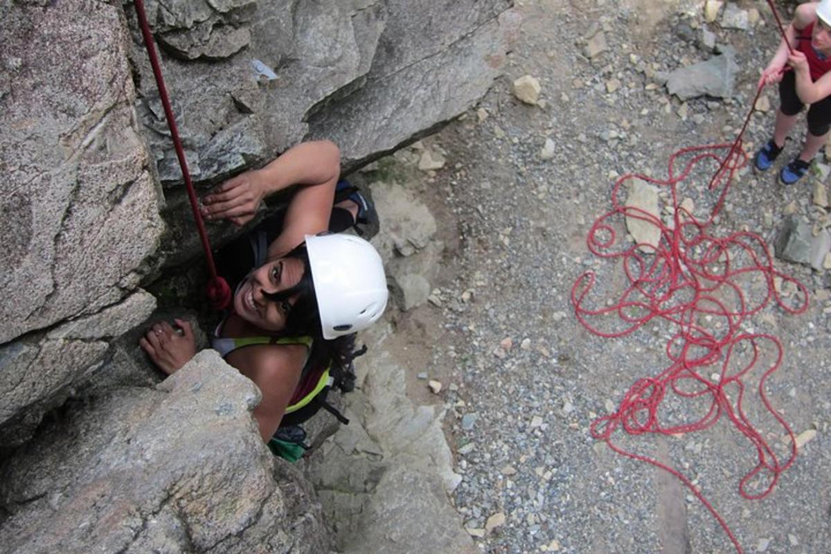 a man laying on the side of a rock
