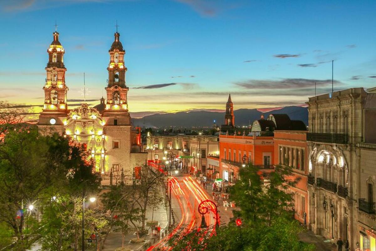 a city with two towers and a street at night