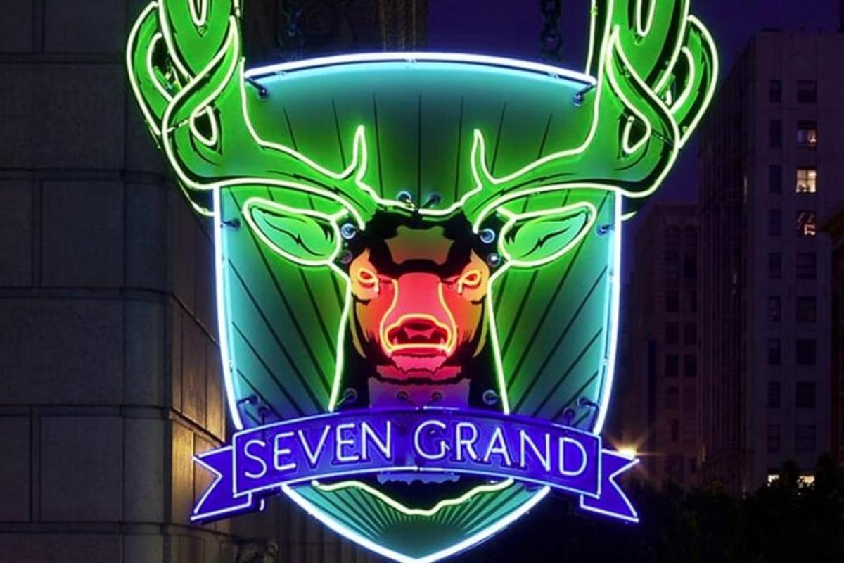 a neon sign for a reindeer on a building