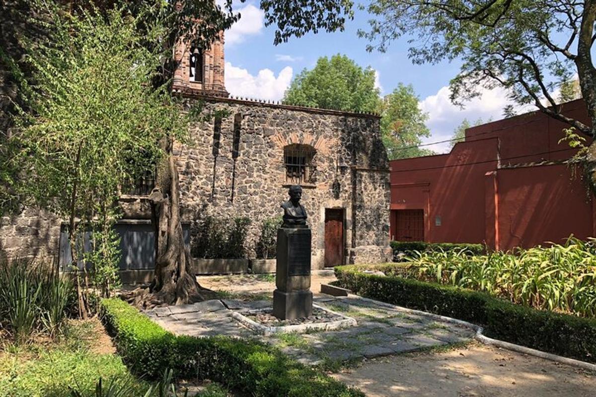 a statue in front of a stone building