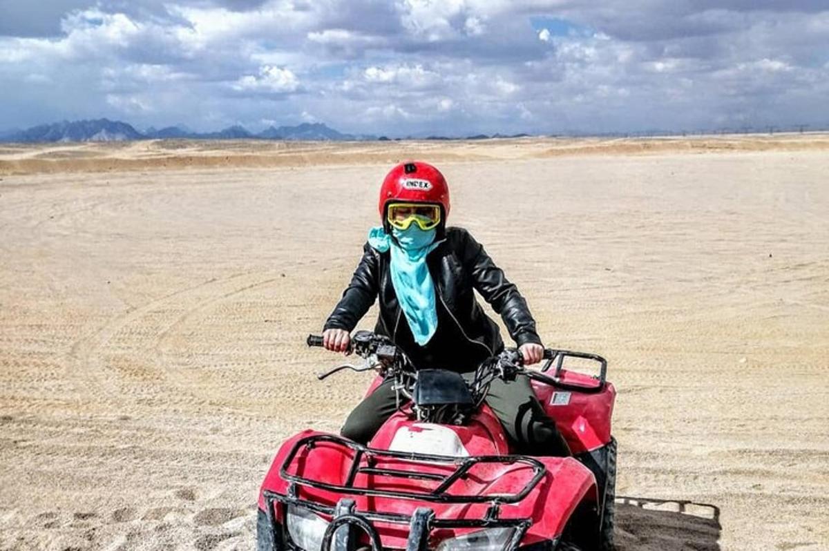 a person riding a quad bike in the desert