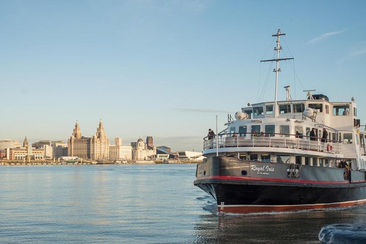 a large boat in the water with a city in the background