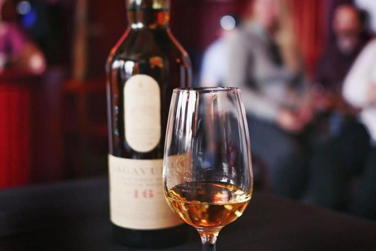 une bouteille de vin posée à côté d'un verre à vin