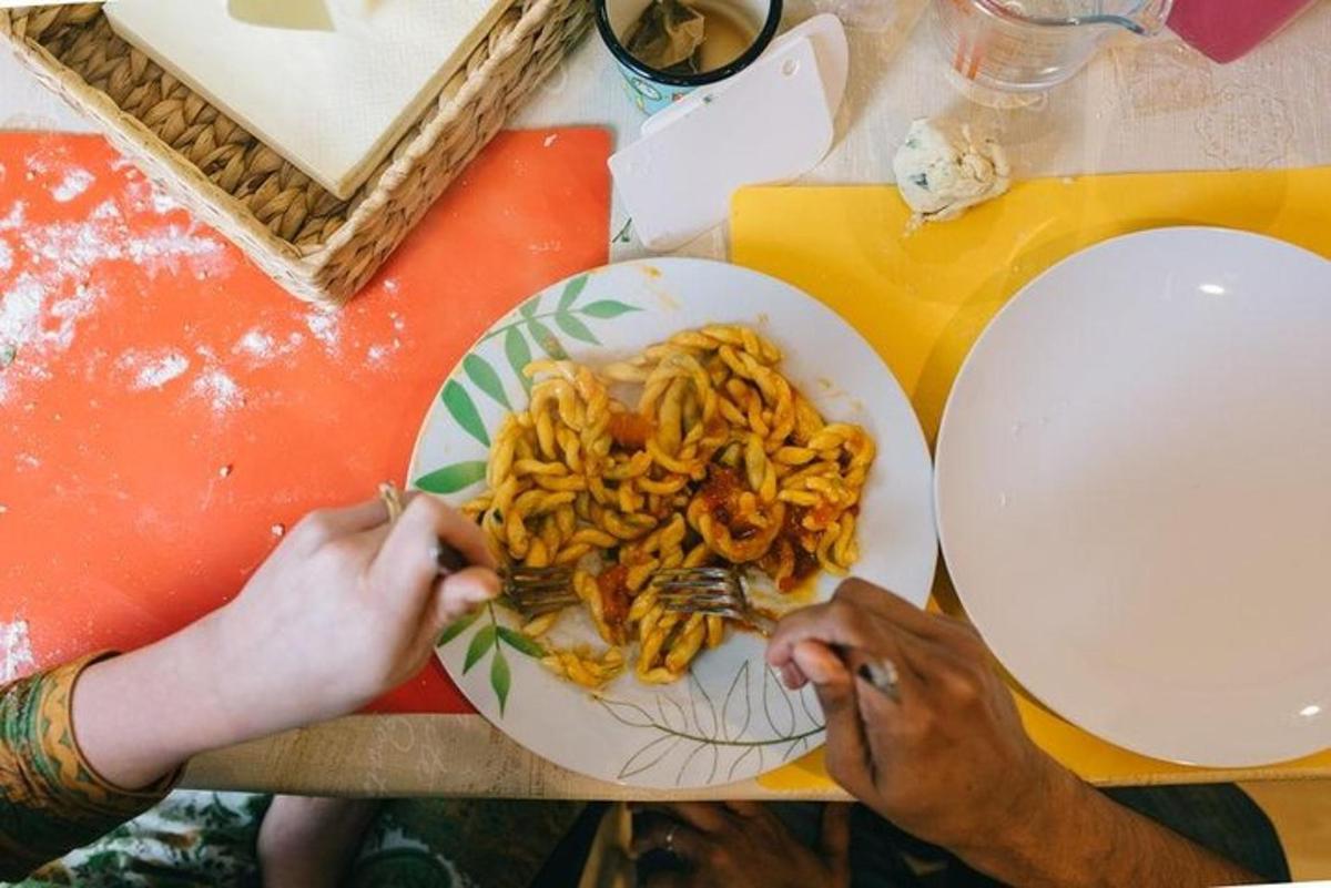 two people sitting at a table with a plate of food