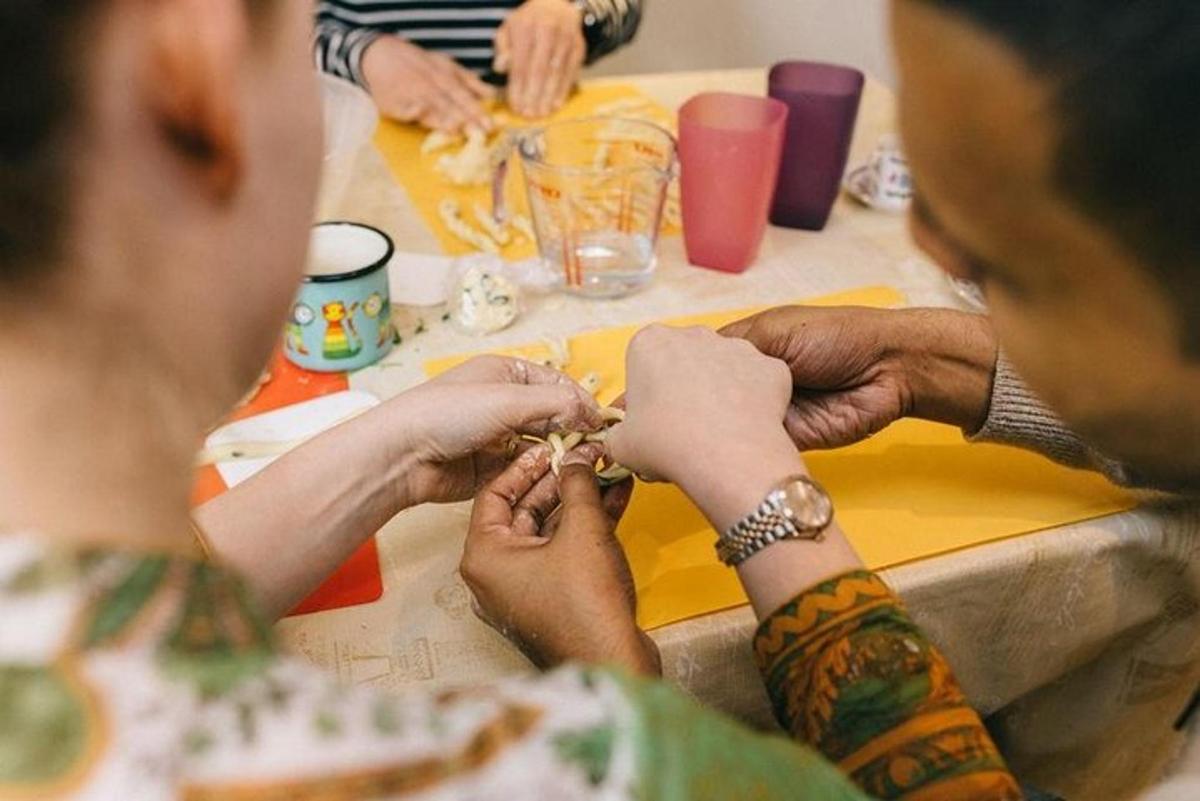 a group of people sitting at a table with tattoos