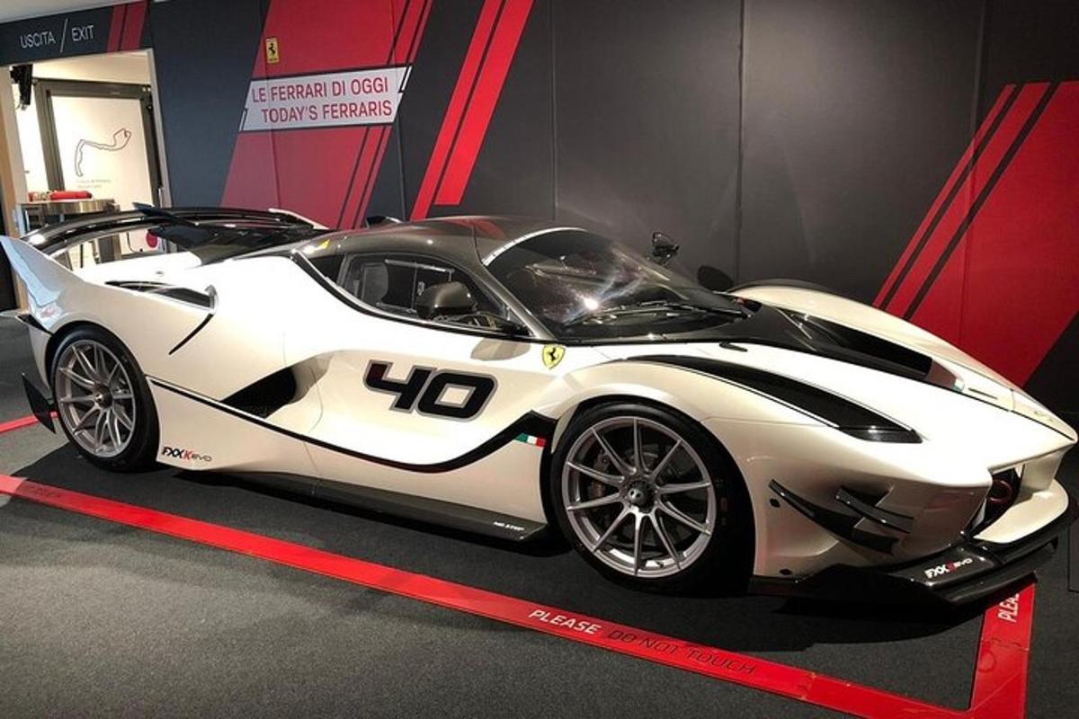 a white sports car on display in a room