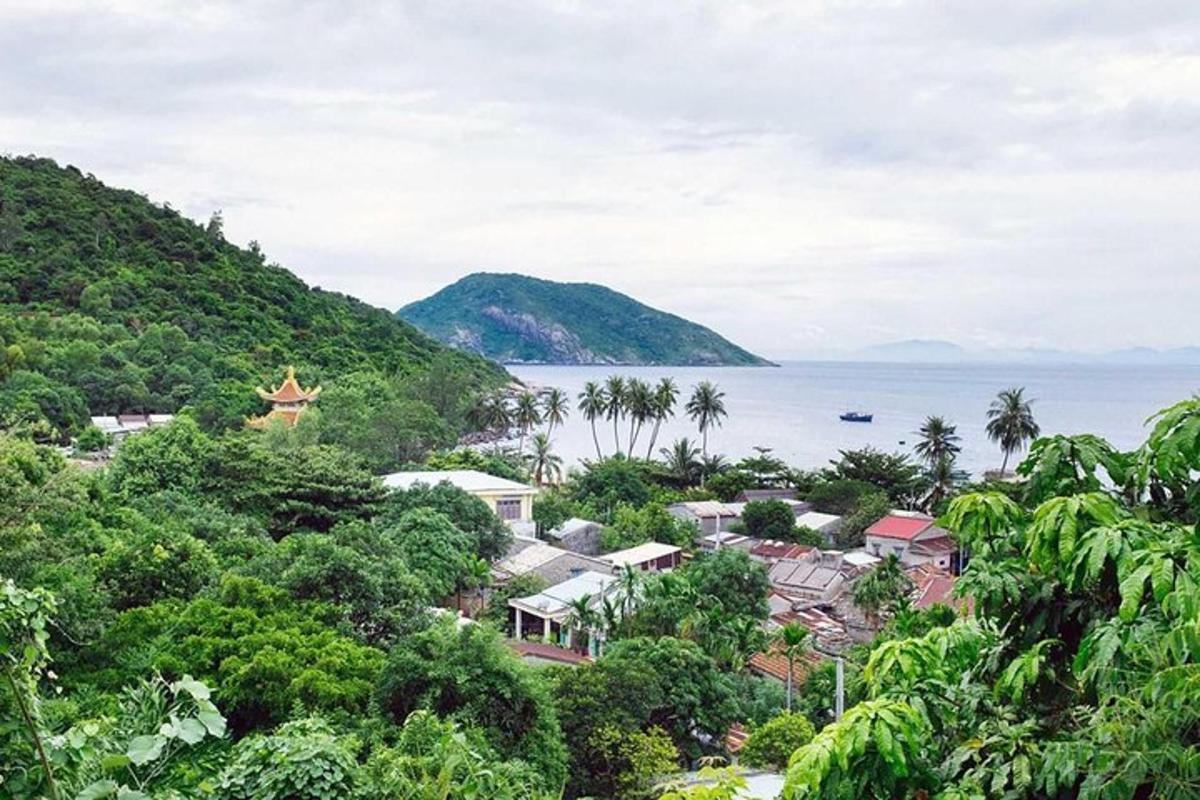 a town on a hill next to the ocean
