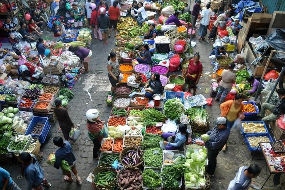 a group of people at a market with vegetables