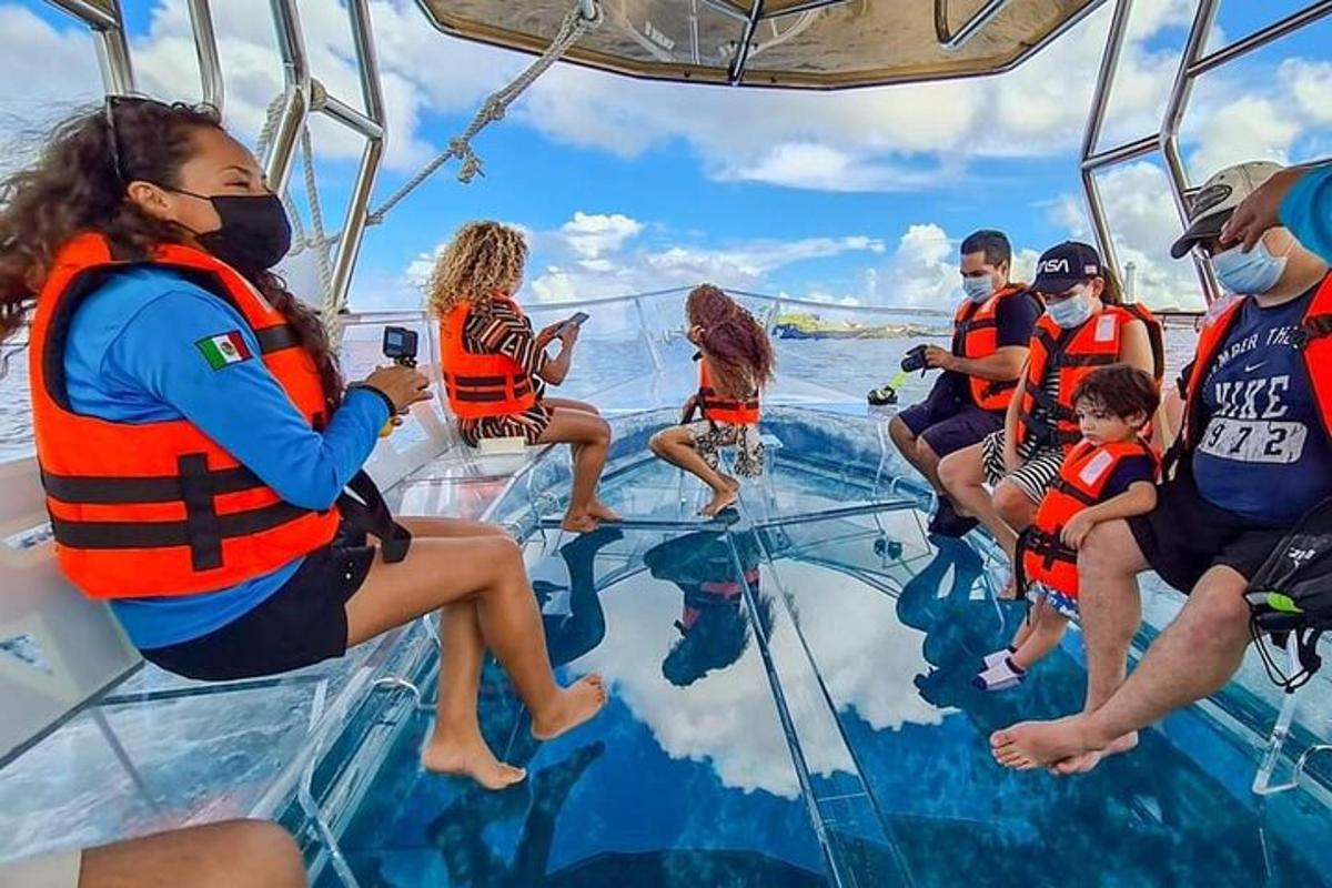 a group of people sitting on the glass floor of a boat