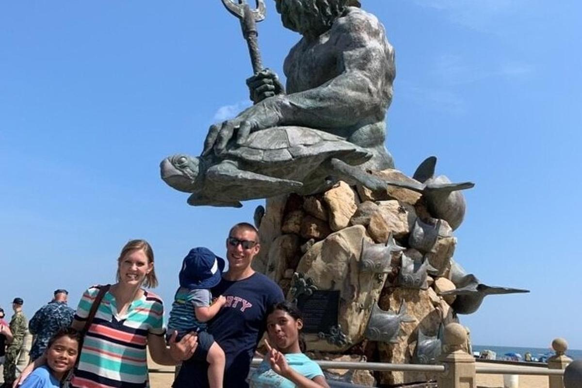 a family standing in front of a statue