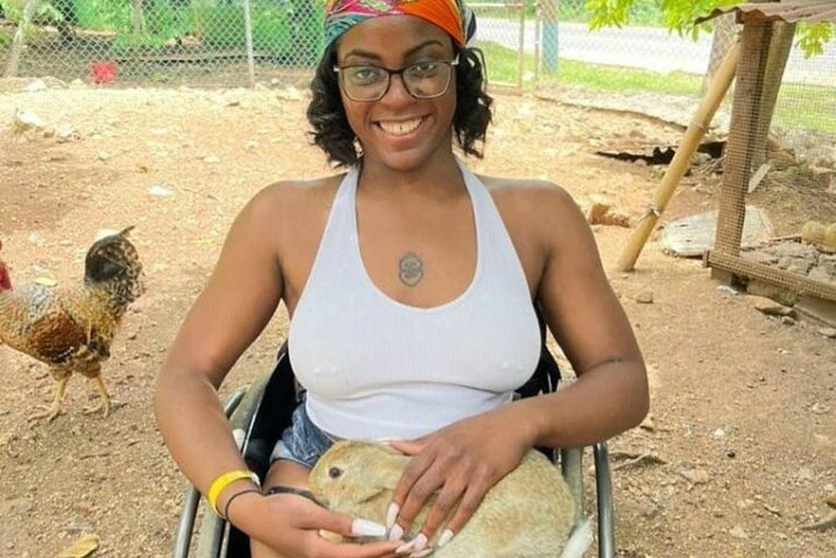 a woman is sitting in a chair with a bird
