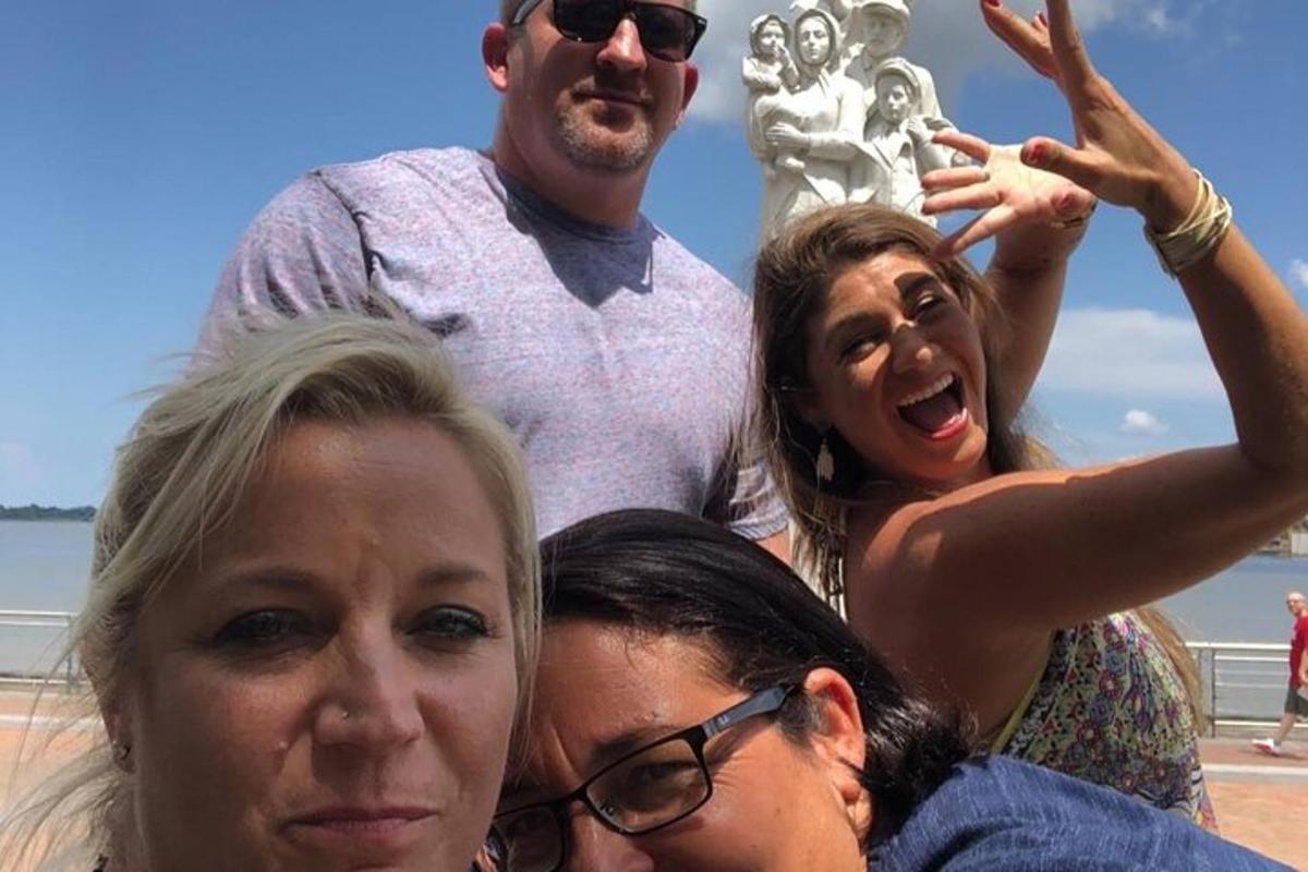 a group of people standing in front of a statue