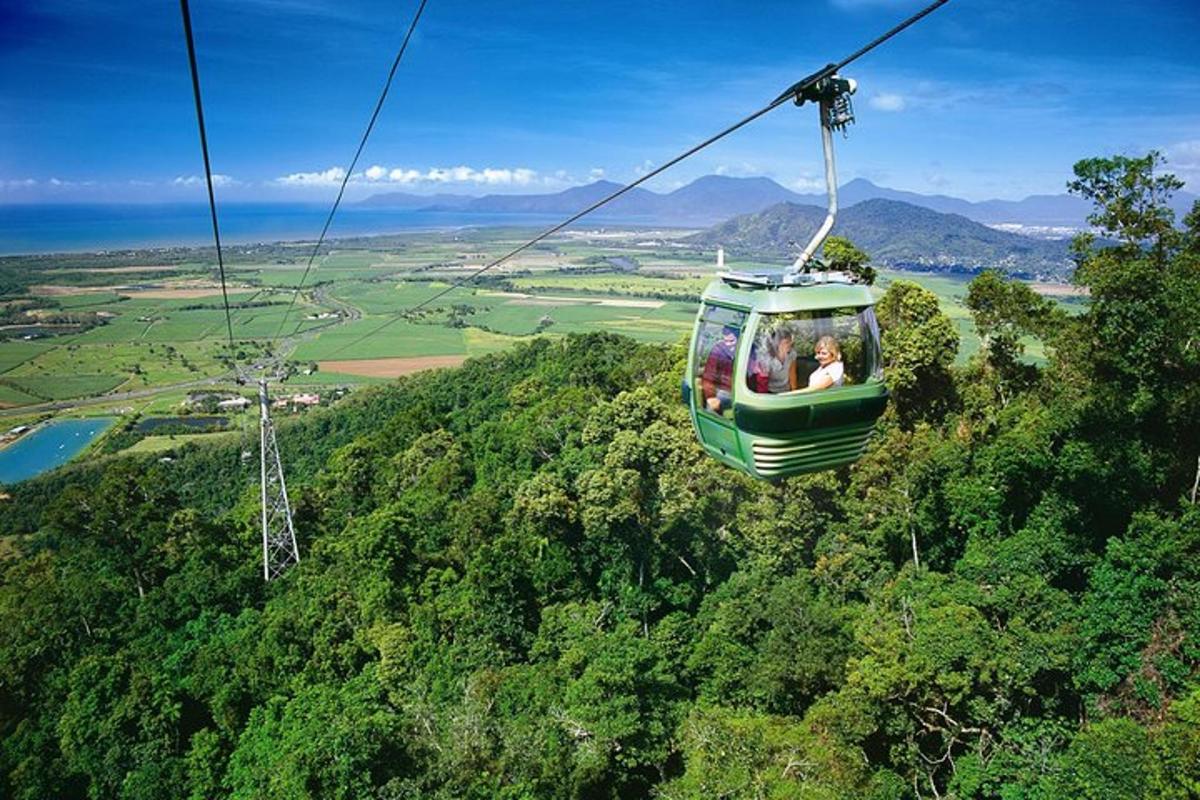 a group of people riding a gondola over a mountain