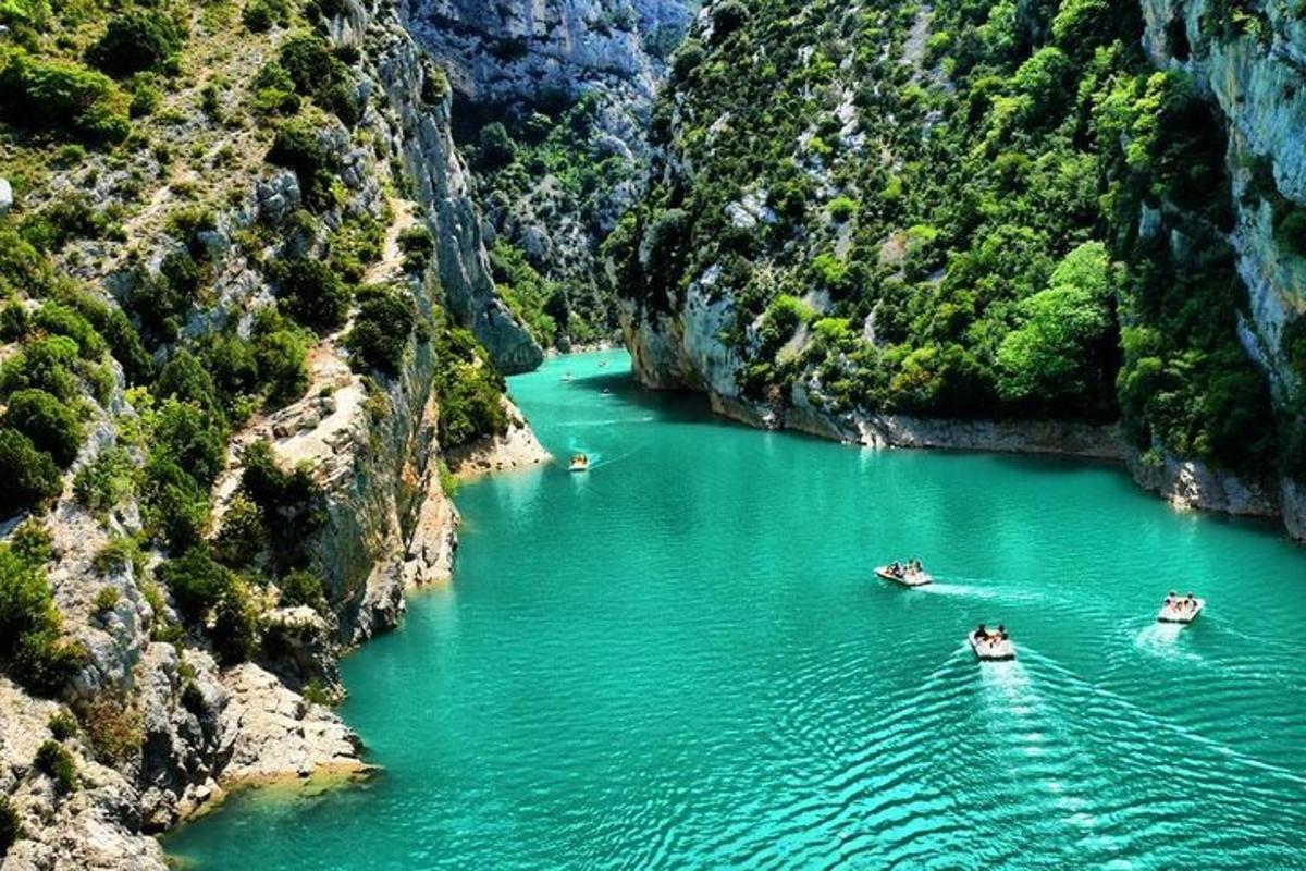 three boats in a river in a canyon