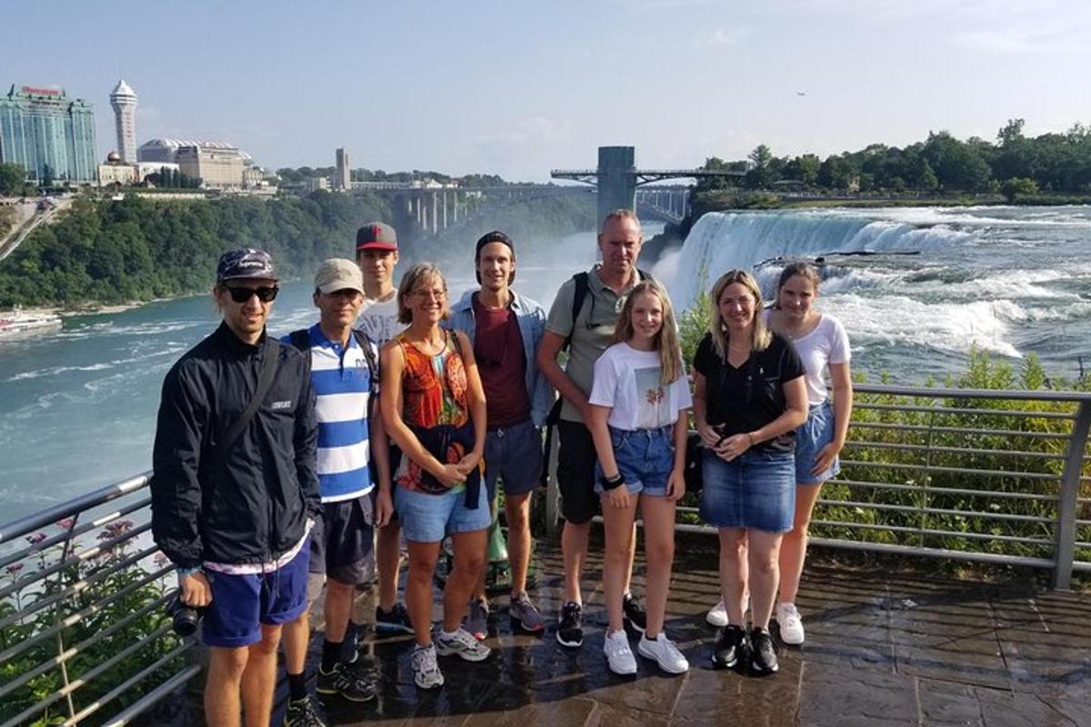 a group of people standing in front of a waterfall