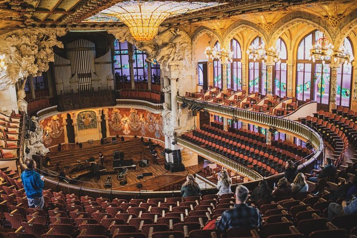 an empty auditorium with people in a large building