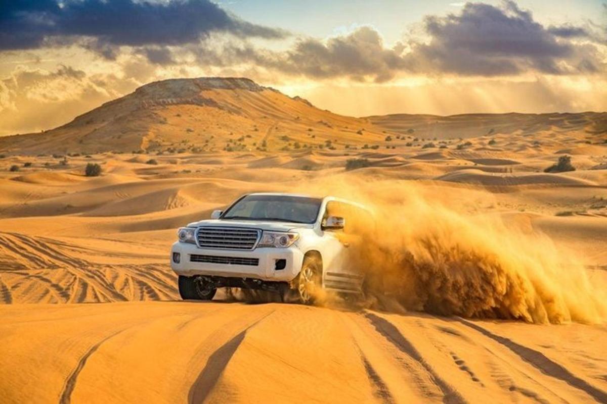 a white truck driving through the desert