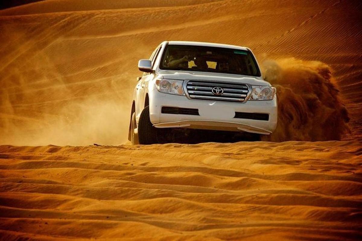 a white truck driving in the desert