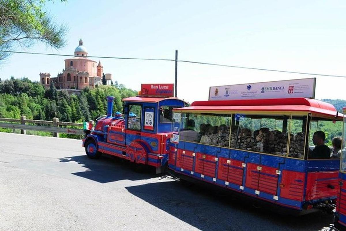 a red and blue train driving down the road